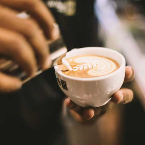 A cappuccino being poured.